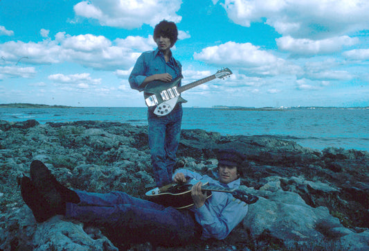 John Lennon and George Harrison at a Beach