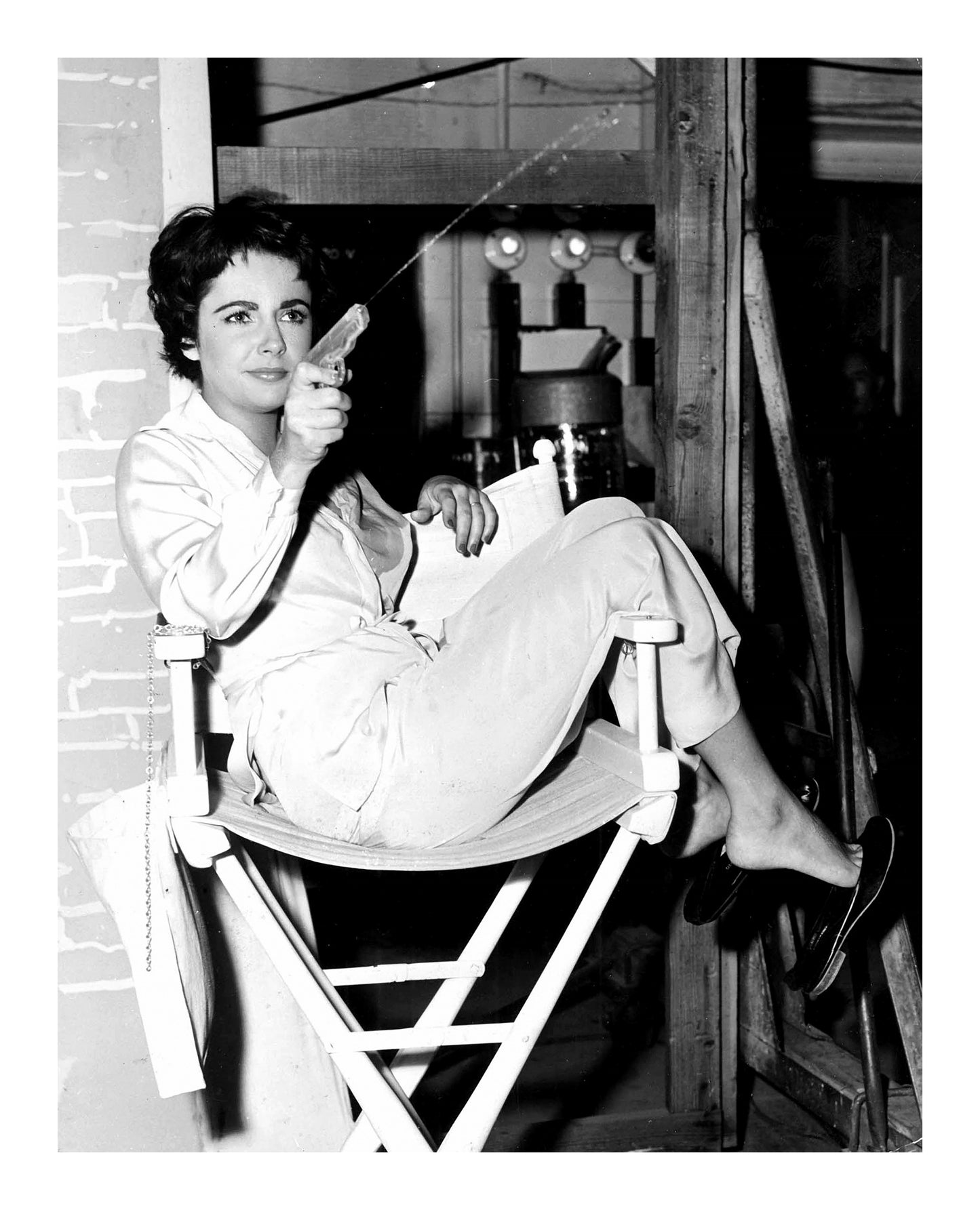 Liz Taylor Shooting Water Gun on the Set