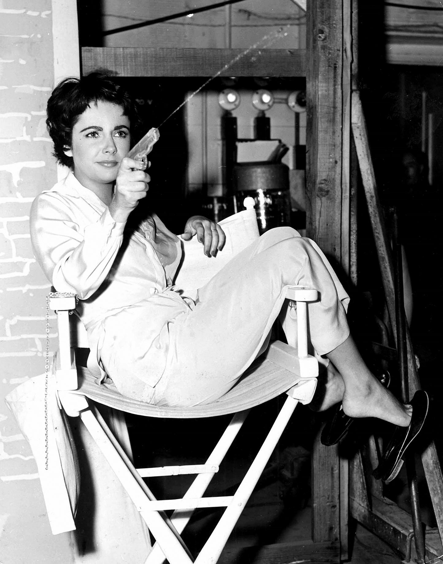 Liz Taylor Shooting Water Gun on the Set