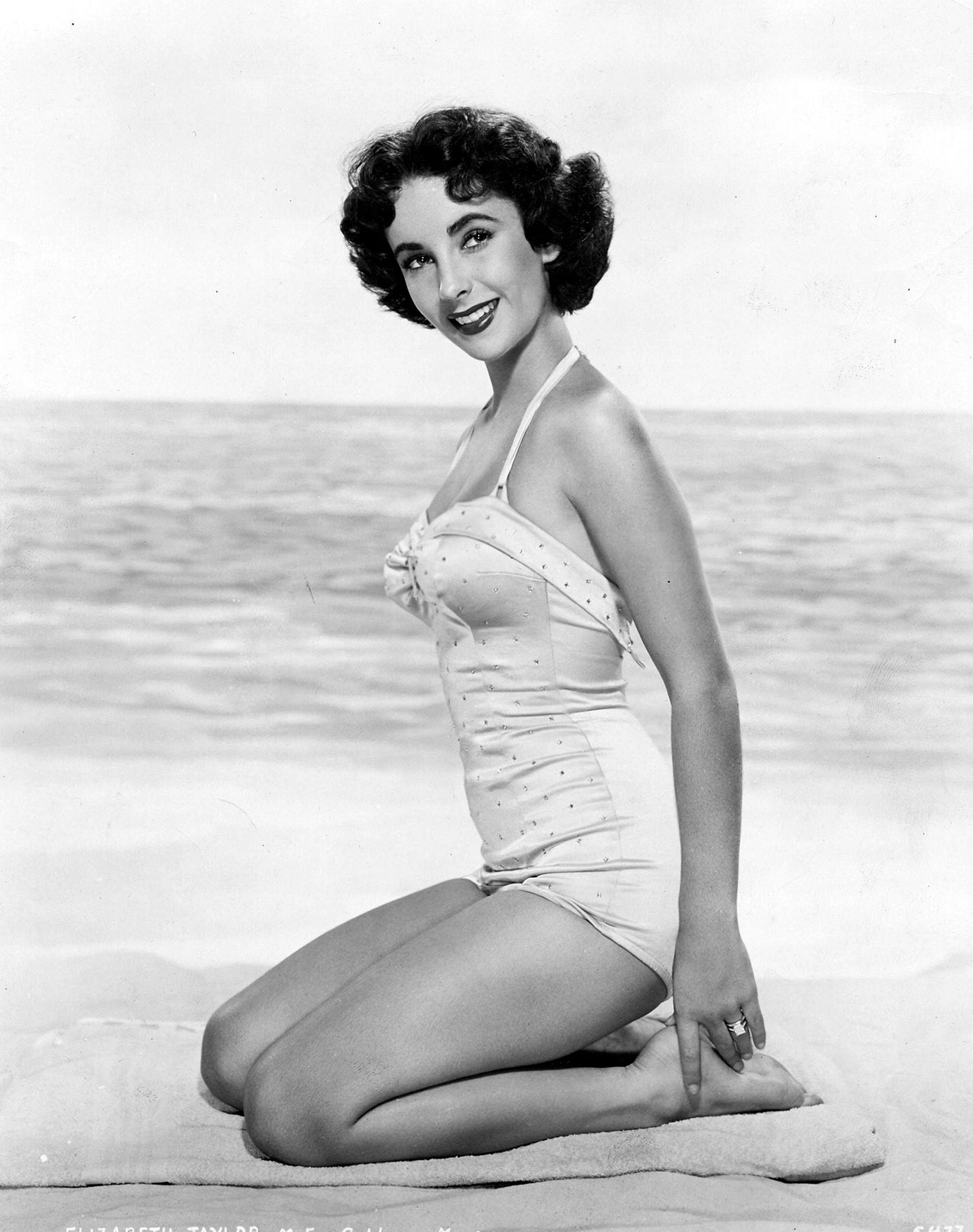 Elizabeth Taylor Kneeling on Beach