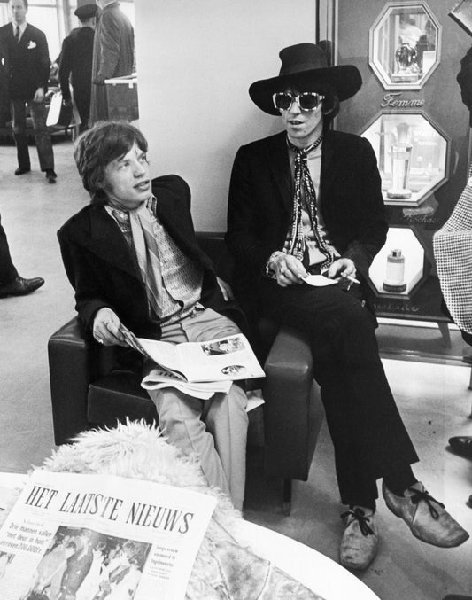 Mick Jagger and Keith Richards Candid with Newspaper